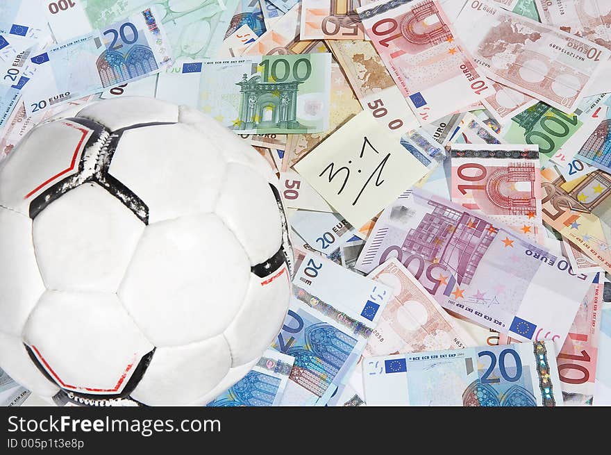 Soccerball and a shett with the right score written on it on a mixture of european papermoney. Soccerball and a shett with the right score written on it on a mixture of european papermoney