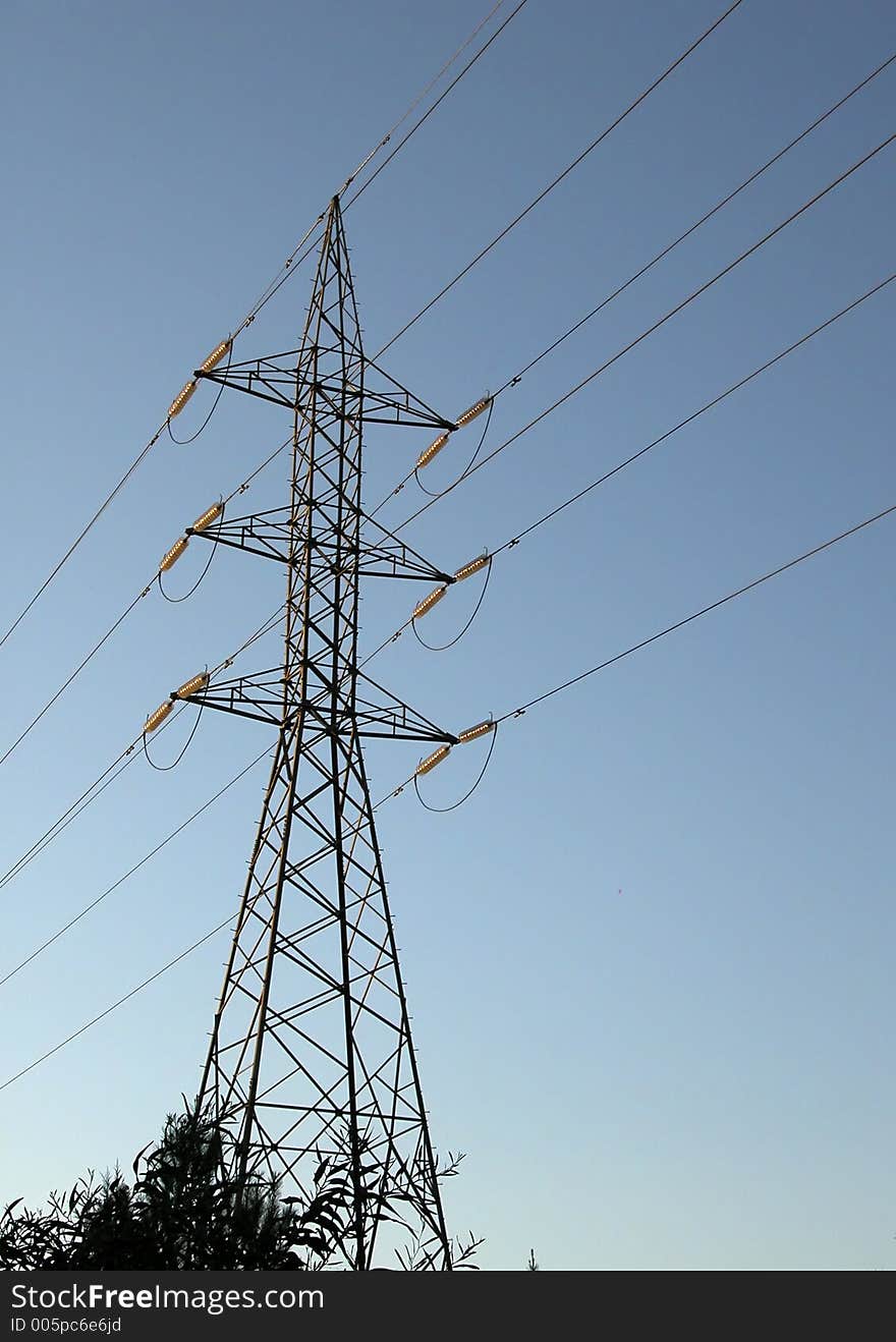 High voltage electricity Pylon against a blue sky. High voltage electricity Pylon against a blue sky