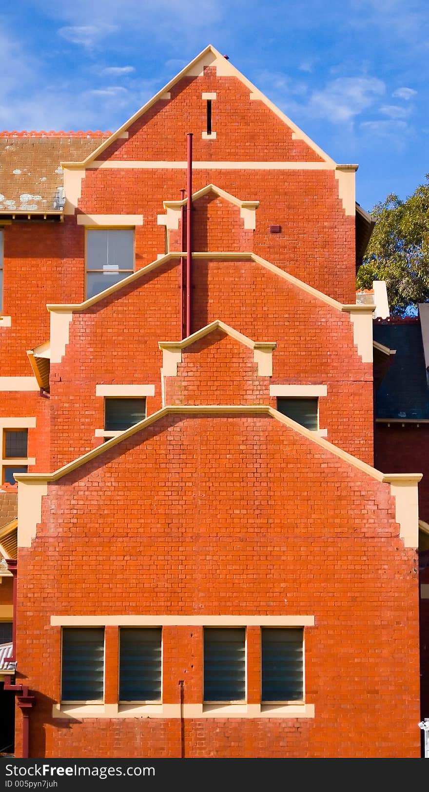 An unusual layered red brick three storey building. An unusual layered red brick three storey building.