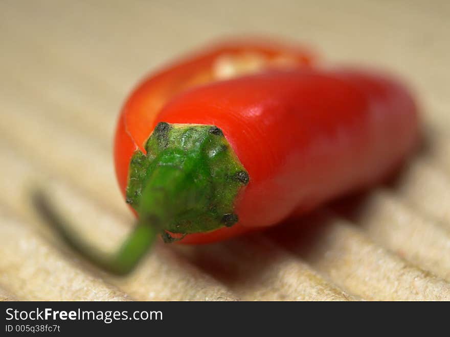 Red chili on textured surface. Red chili on textured surface