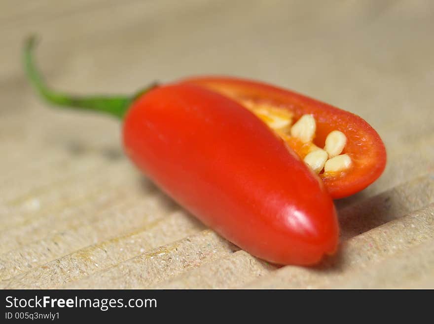 Red chili on textured surface. Red chili on textured surface