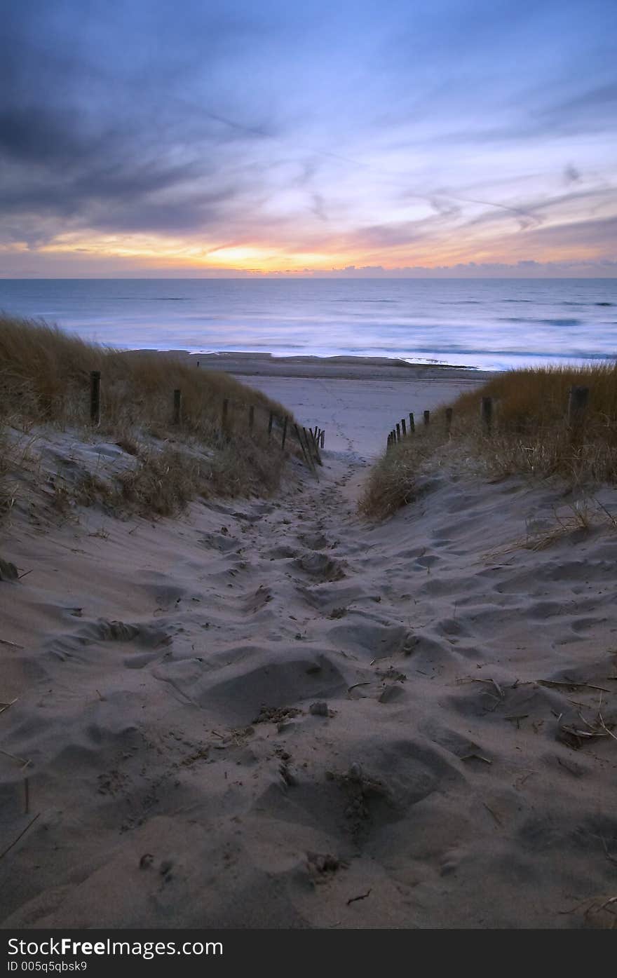 Path through the dunes to the ocean at sunset. Path through the dunes to the ocean at sunset