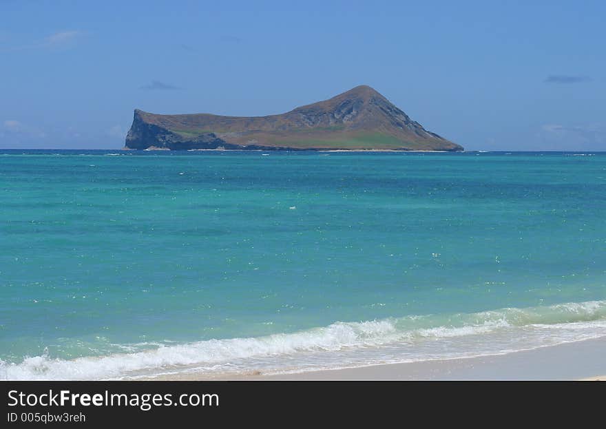 View of a small, desserted island as scene from the shore of the island of Oahu, Hawaii. View of a small, desserted island as scene from the shore of the island of Oahu, Hawaii.