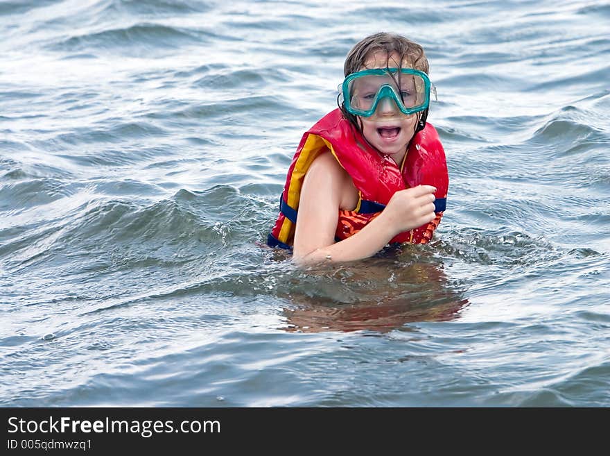 Young girl with swim goggles suprised by what she saw. Young girl with swim goggles suprised by what she saw