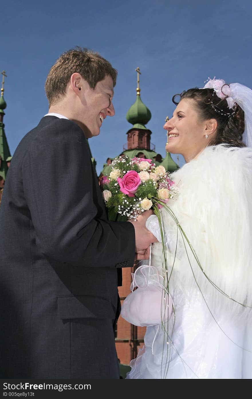 Newlywedses on street before church. Newlywedses on street before church