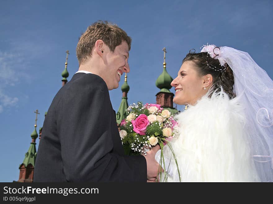 Newlywedses on street before church. Newlywedses on street before church