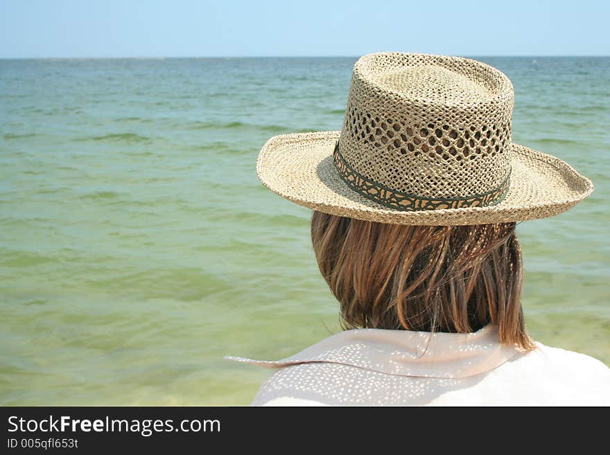 Girl with a hat fixing the horizon, vacation is comming. Girl with a hat fixing the horizon, vacation is comming.