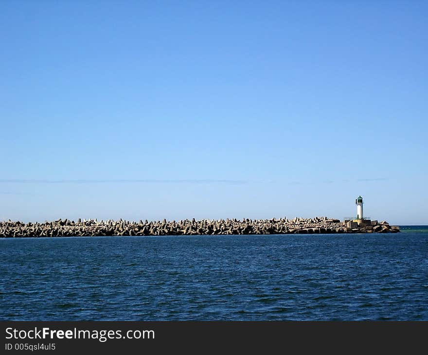 Breakwater, beacon and blue sky. Breakwater, beacon and blue sky.