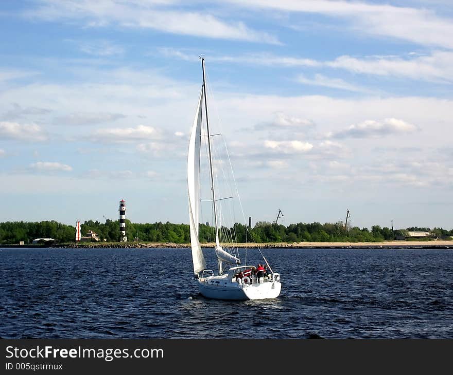 Yacht on a background dark blue sky and white clouds. Yacht on a background dark blue sky and white clouds.