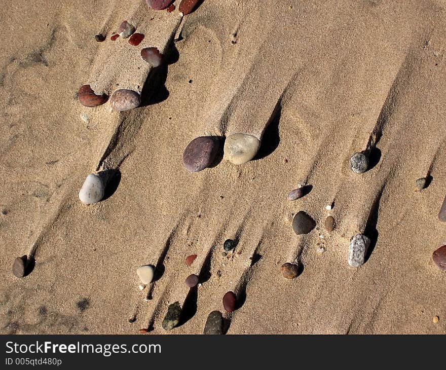 Sea, sand and varicoloured stones. Sea, sand and varicoloured stones.