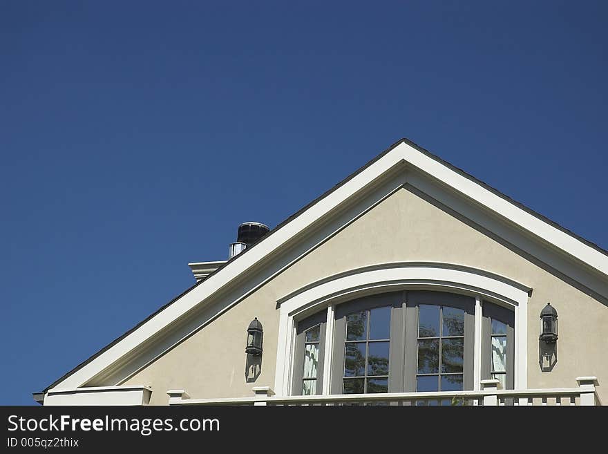 Home rooftop against a blue sky. Home rooftop against a blue sky