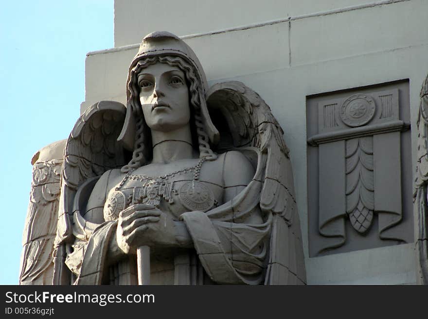 Stone angel on top of building. Stone angel on top of building.