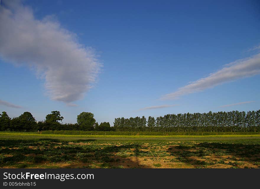 Two cloud streams over British farmland