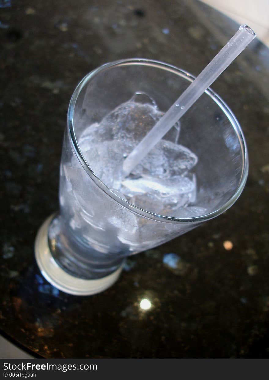 Water glass top view on marble with straw. Water glass top view on marble with straw