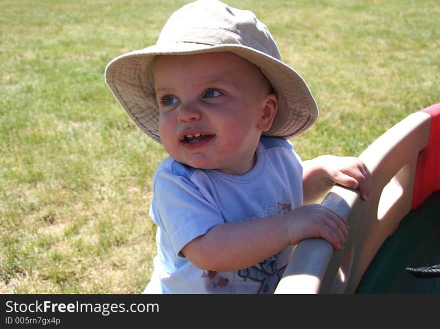 Little Boy Hanging onto Wagon