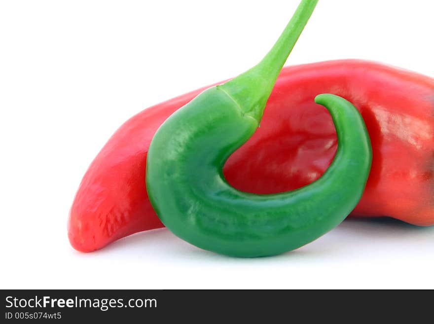 Red banana chilli peppers isolated on white, with green stalk, macro, close up, shallow dof