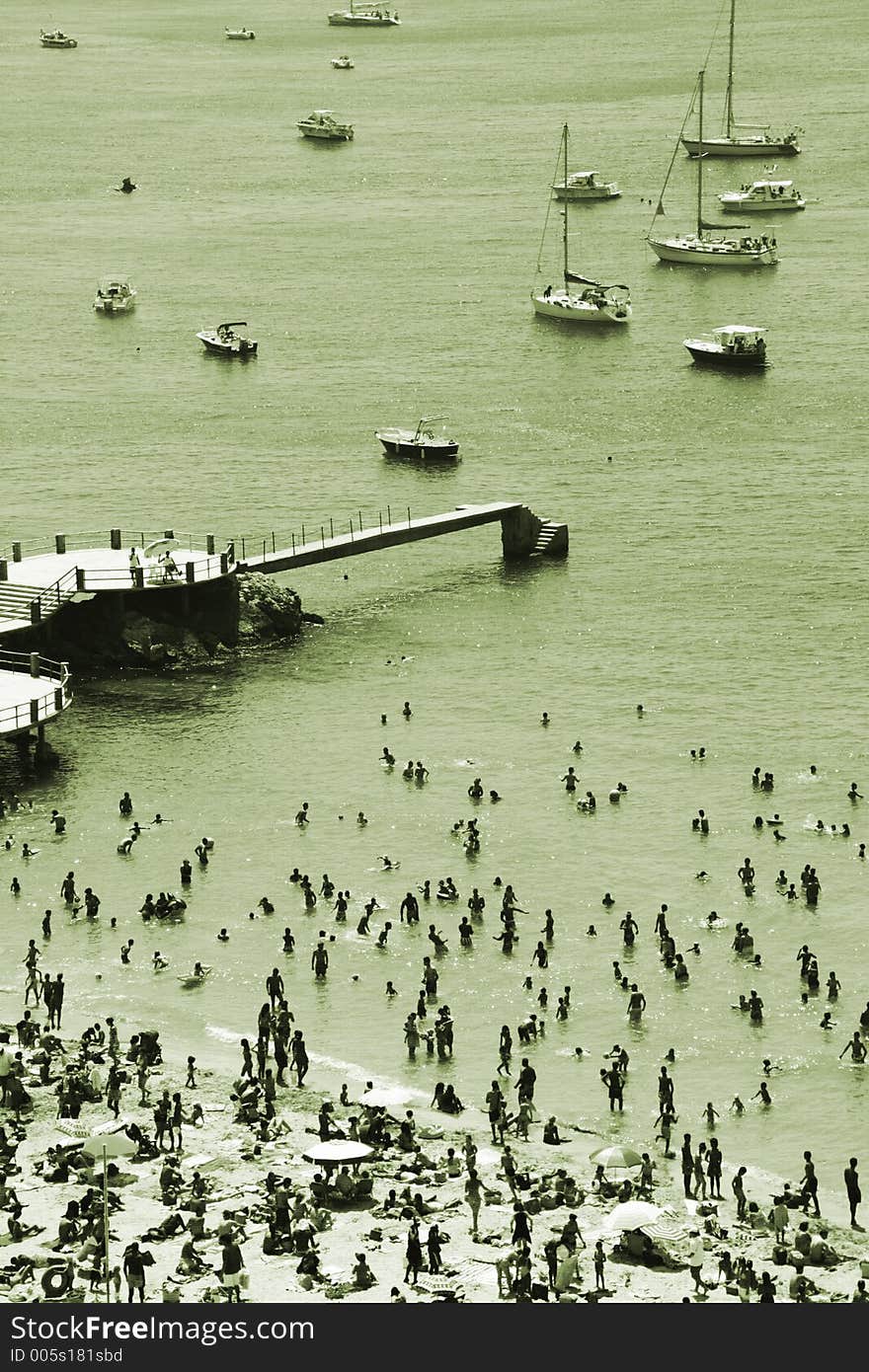 Crowded beach in marseille, with small boats anchored close off-shore. Crowded beach in marseille, with small boats anchored close off-shore