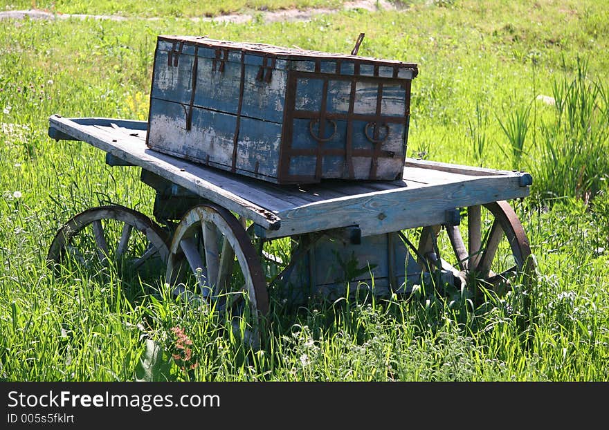 Old wagon with box in field