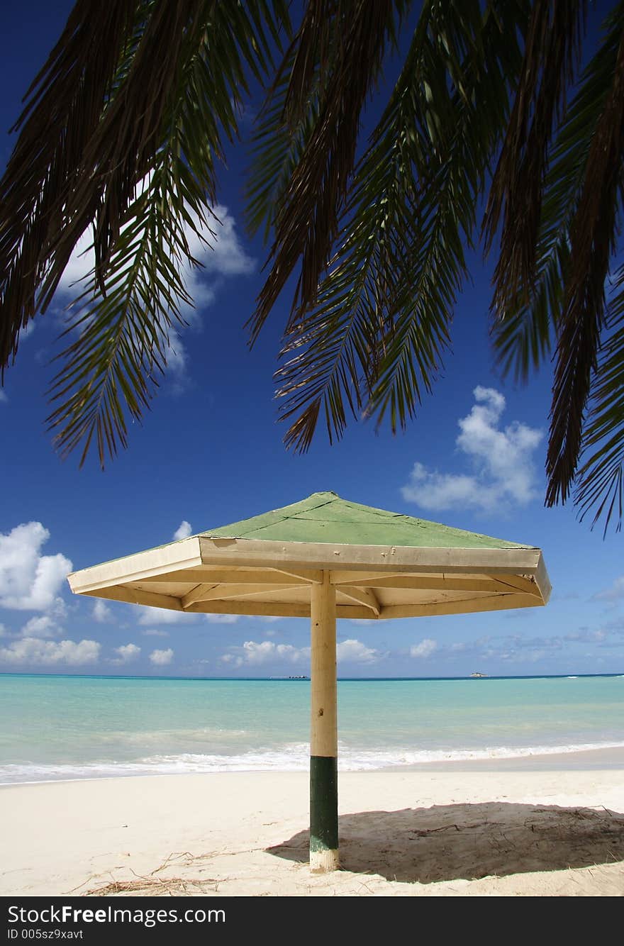 Parasol with palm leaf at a caribbean beach. Parasol with palm leaf at a caribbean beach