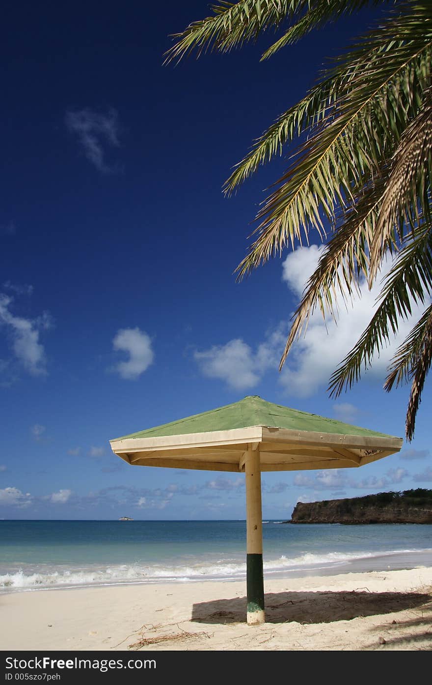 Parasol with palm leaf at a caribbean beach. Parasol with palm leaf at a caribbean beach