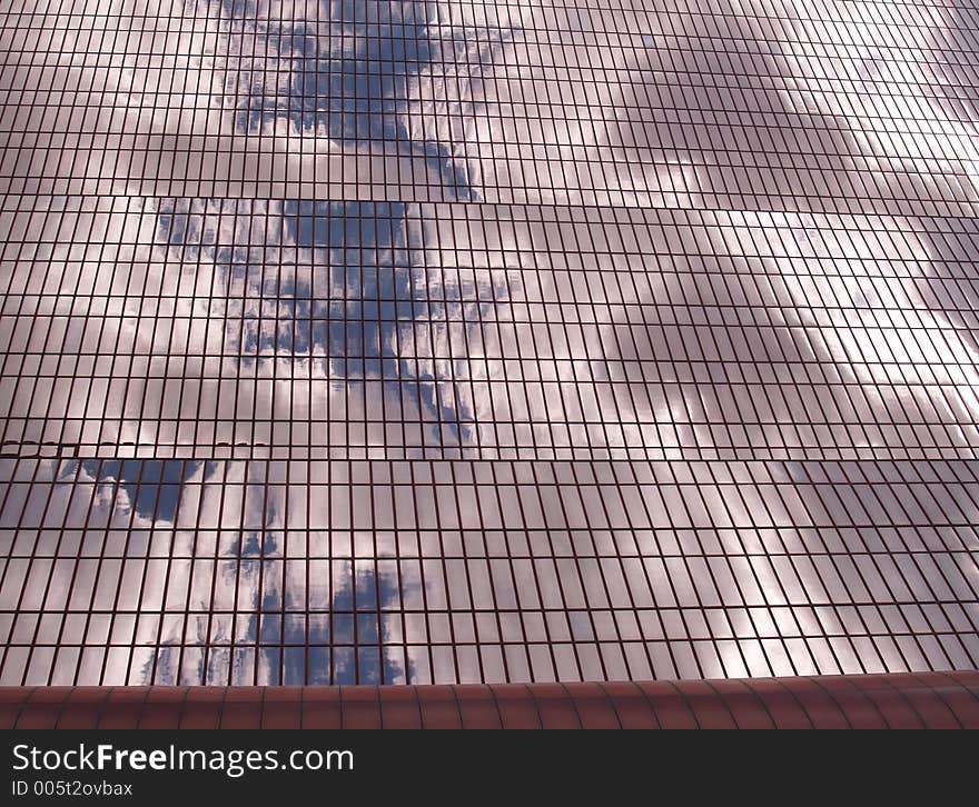 Blue sky and clouds reflecting off a modern building. Blue sky and clouds reflecting off a modern building