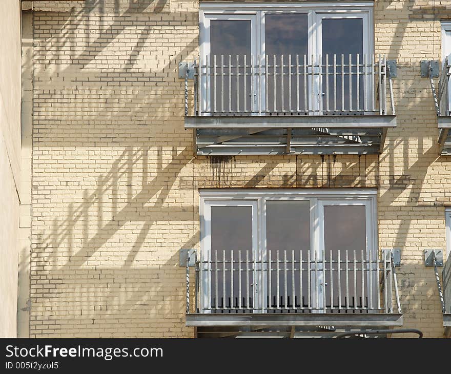 City building balconies with staircase reflections. City building balconies with staircase reflections