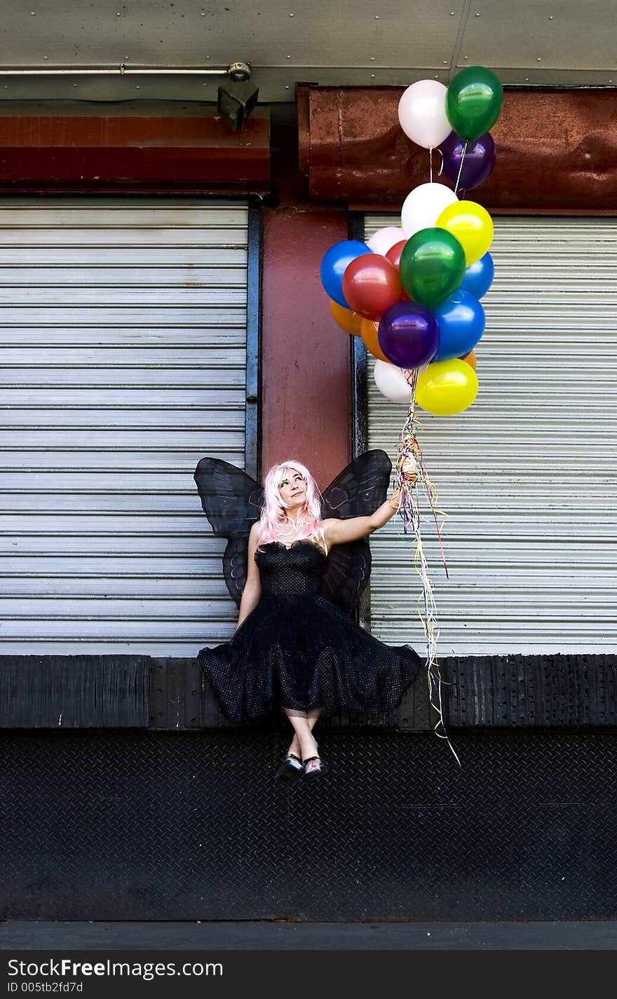 Fairy with balloons in an urban setting