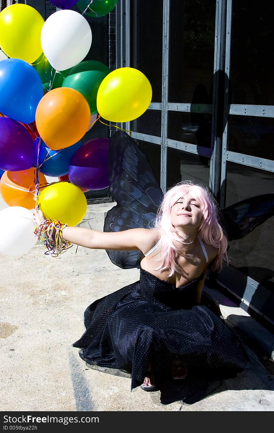 Fairy with balloons enjoying the sun. Fairy with balloons enjoying the sun