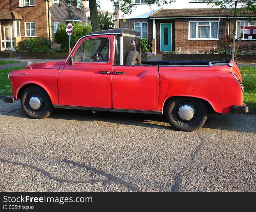 An antique pick up on a street in London subburb. An antique pick up on a street in London subburb