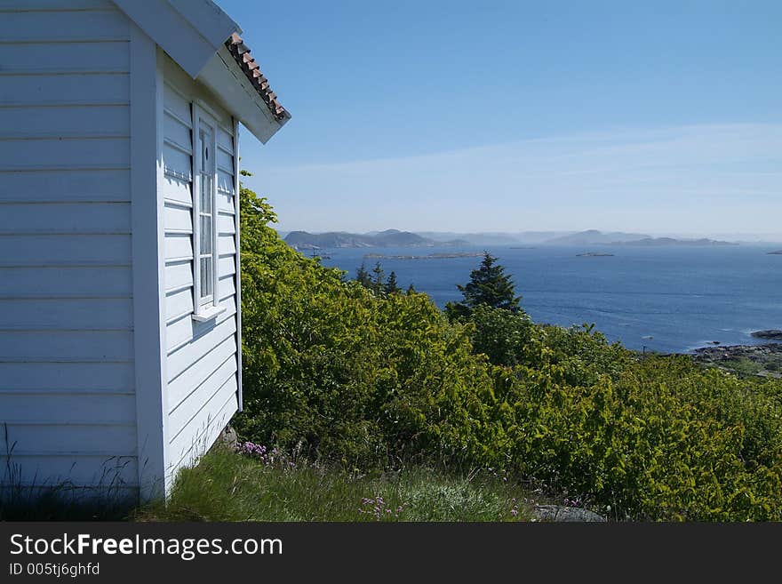 Small, white, wooden cabin overlooking the archipelago outside Loshavn near Farsund in Vest-Agder on the south coast of Norway. Small, white, wooden cabin overlooking the archipelago outside Loshavn near Farsund in Vest-Agder on the south coast of Norway