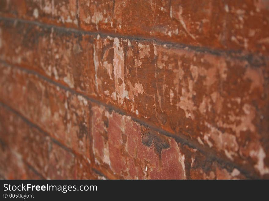 Old red brick wall with remenants of a white wash