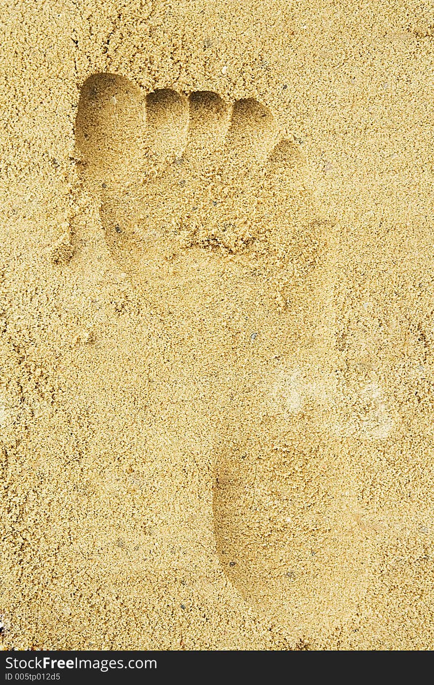 Trace Of A Female Foot On Sand