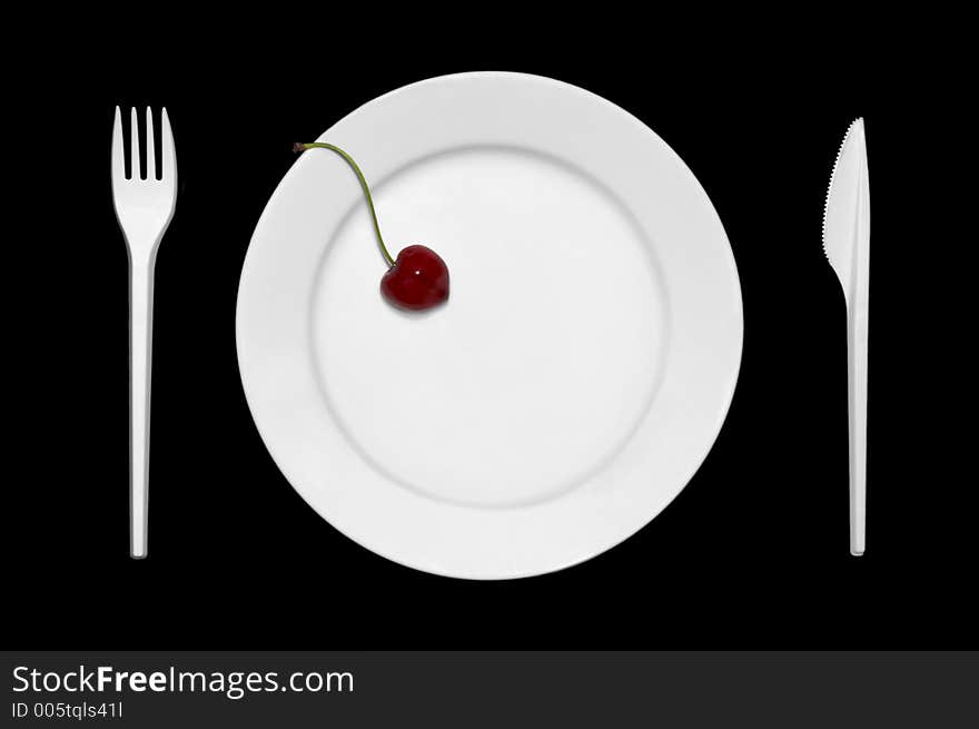 Cherry on the plate together with cutlery. Cherry on the plate together with cutlery