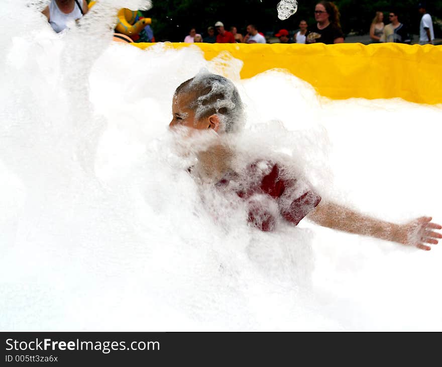 That is one big, fun wall of bubbles rolling twards this boy.  He will be burried in seconds.  The Fire Dept uses thier bubble machine at local festivals here in Roanoke VA. That is one big, fun wall of bubbles rolling twards this boy.  He will be burried in seconds.  The Fire Dept uses thier bubble machine at local festivals here in Roanoke VA.