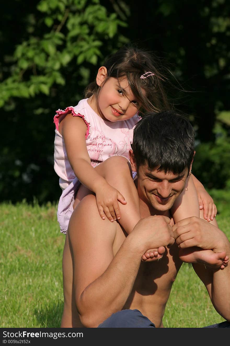 Little girl sitting on the shoulders of her father. Little girl sitting on the shoulders of her father.