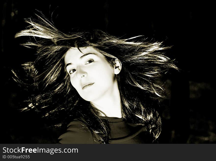 Woman shaking is hair (toned in ps)