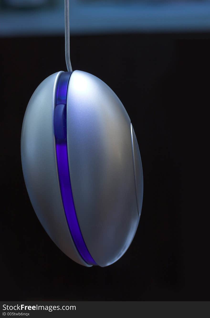 Blue Optical mouse in a dark background