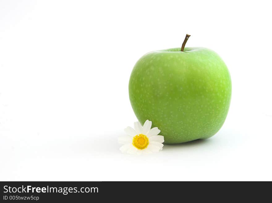 Green Apple isolated in a white background with flowers and reflection. Green Apple isolated in a white background with flowers and reflection