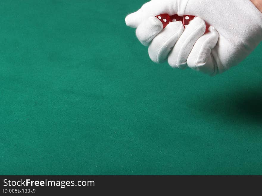 Dices being thrown in a craps game, or yatzee or any kind of dice involved game, Dices are a clear red color on a green felt table. Dices being thrown in a craps game, or yatzee or any kind of dice involved game, Dices are a clear red color on a green felt table