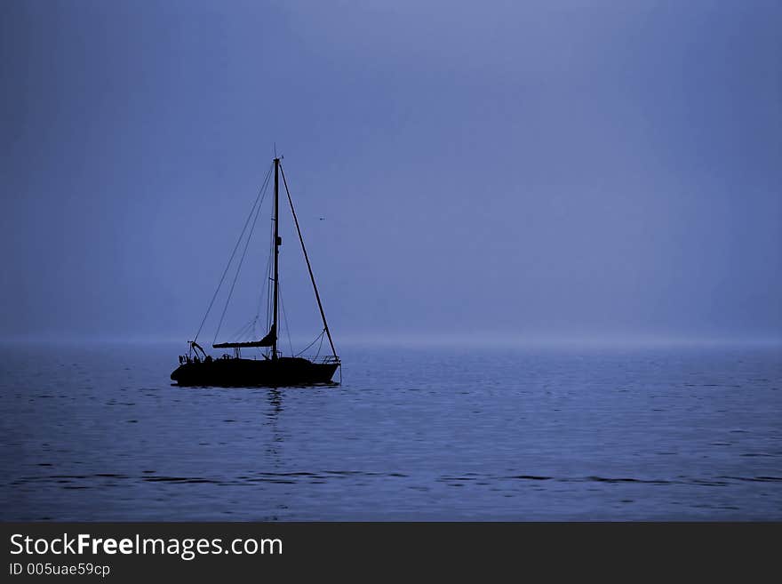 Black boat in blue sky