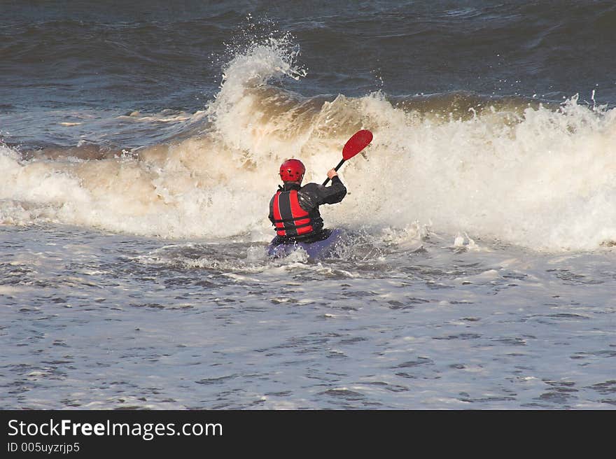 Man in canoe with waves. Man in canoe with waves