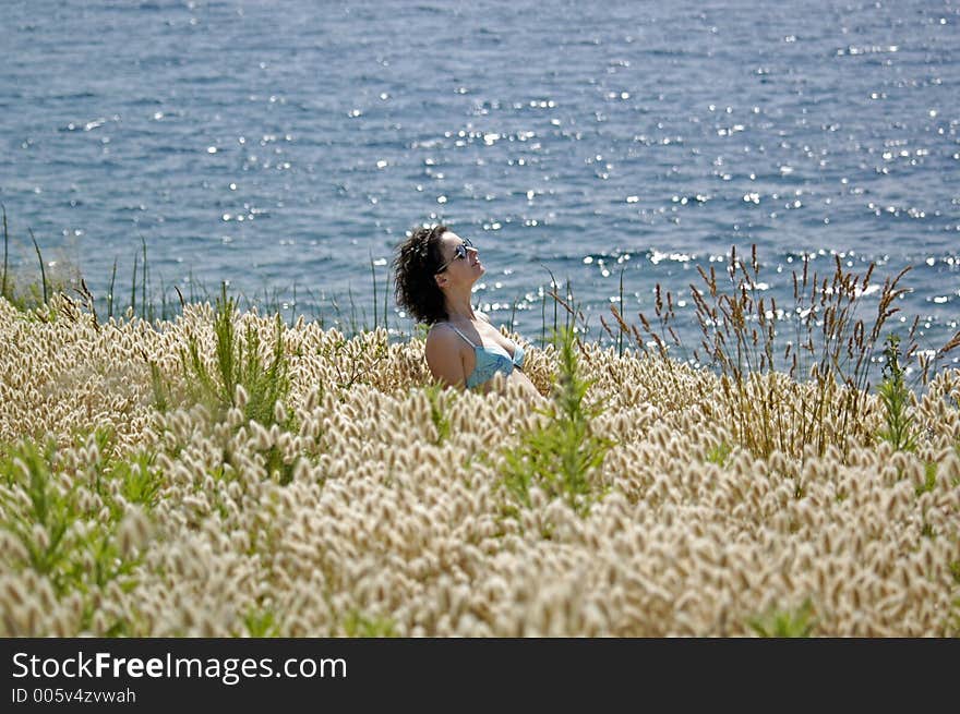 Girl in grass on the coast