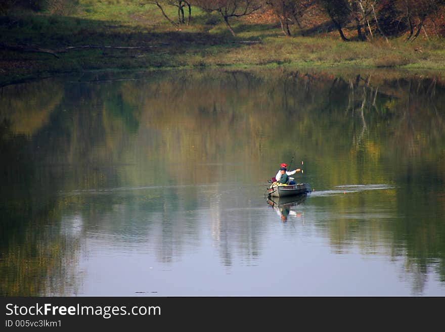 Men in a Rowboat Fishing in a Lake