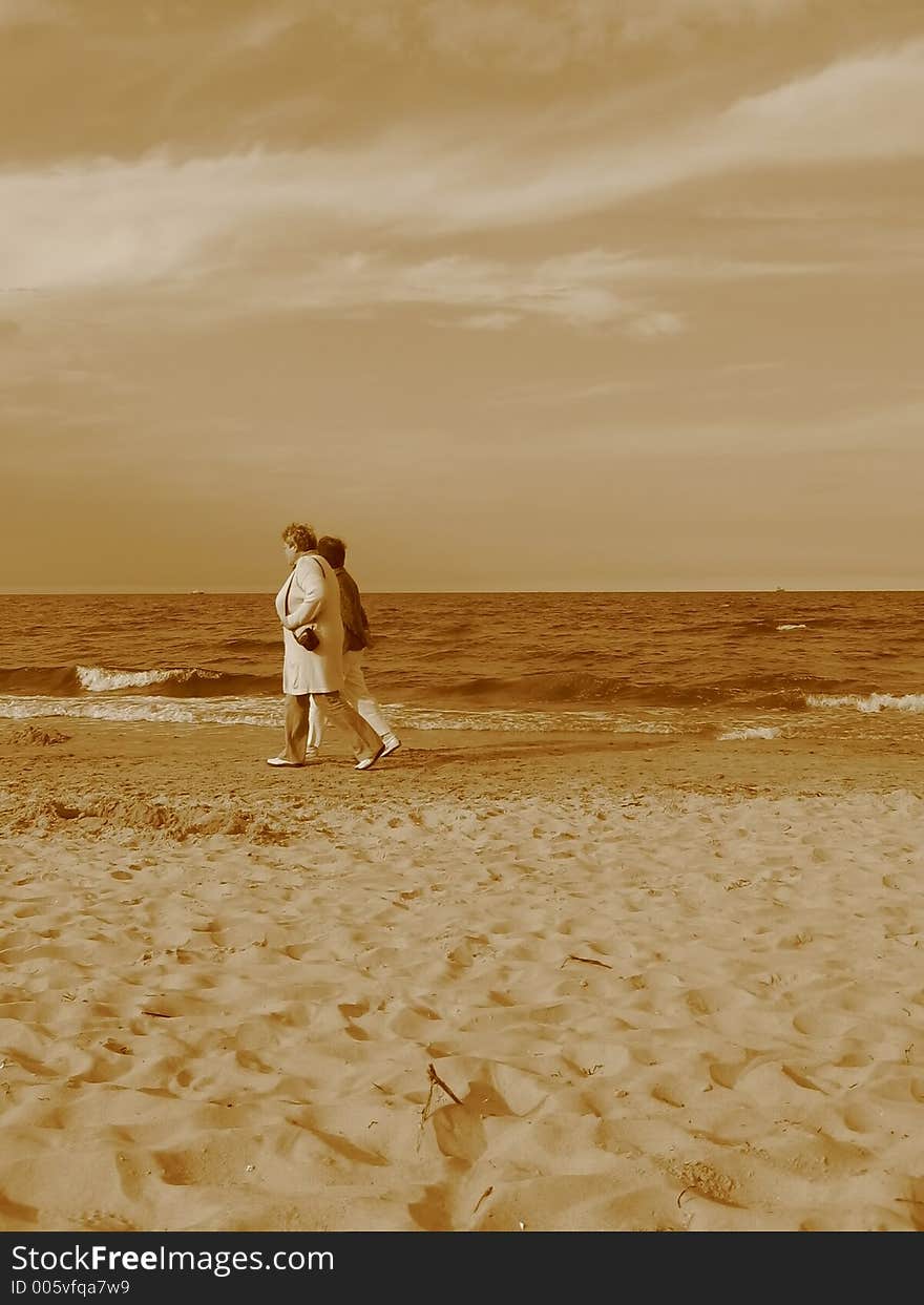 Two women walking on the beach