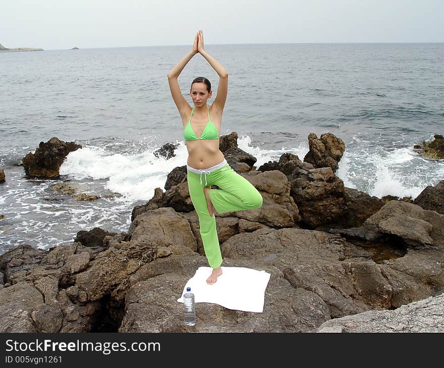 A Girl meditating on the rocks. A Girl meditating on the rocks