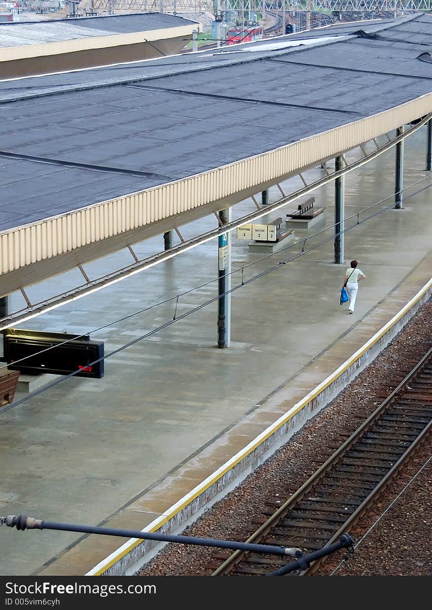 Woman with luggage heading to railway station platform. Woman with luggage heading to railway station platform