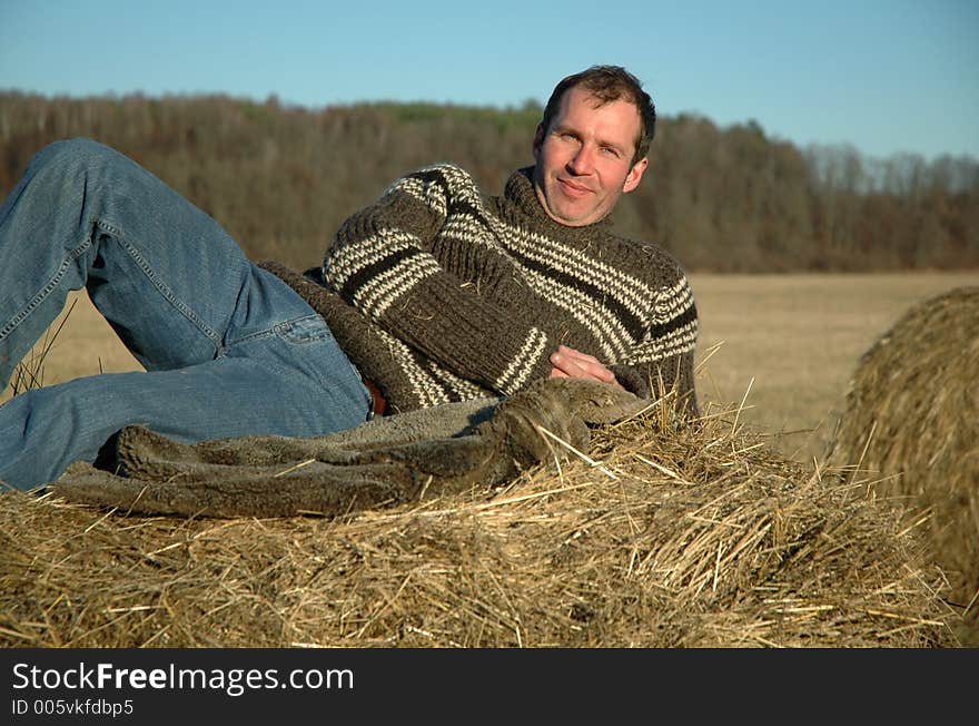 Man having rest on haystack