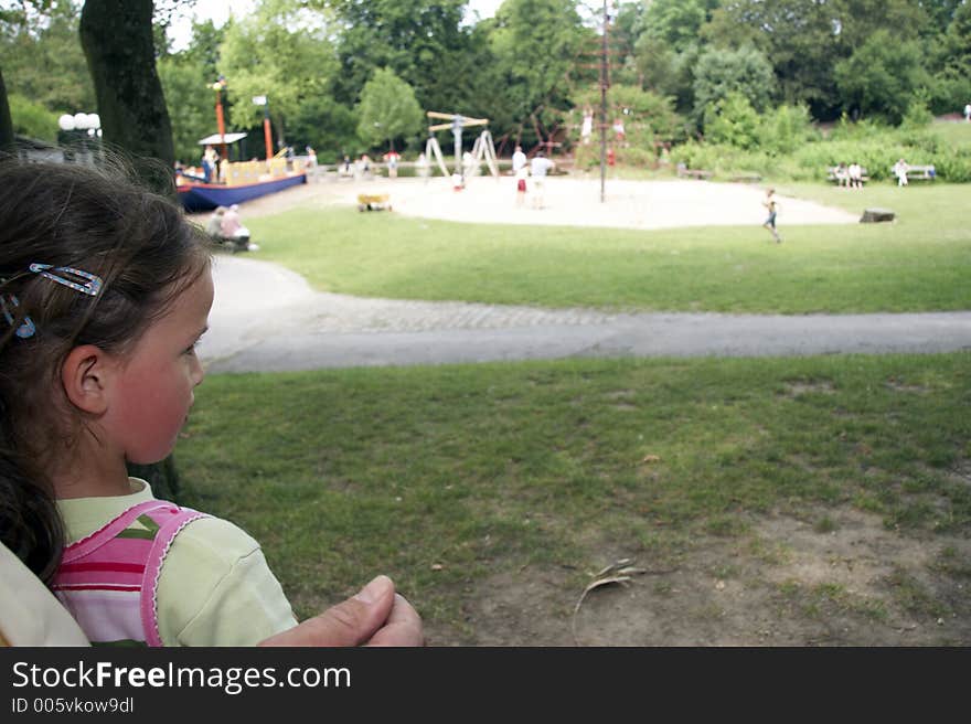 Girl looking at a playground in front. Girl looking at a playground in front