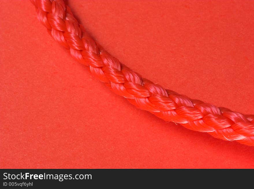 Red rope macro on red background