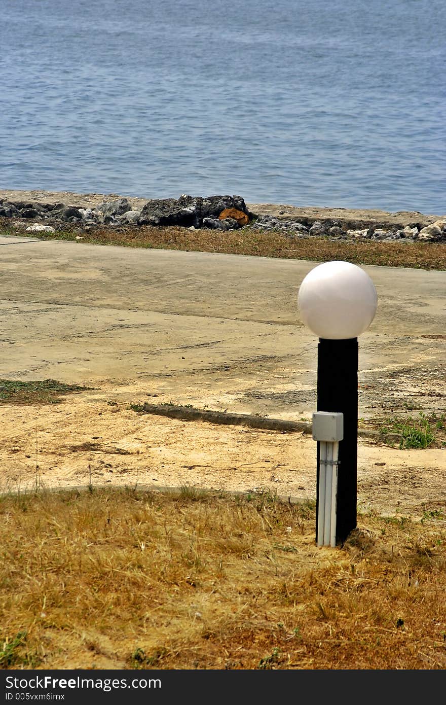 A street light beside a beautiful sea. A street light beside a beautiful sea